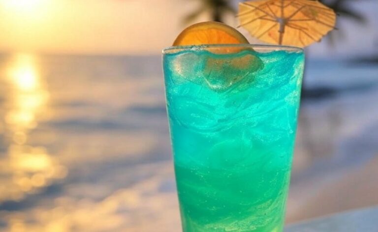 Refreshing turquoise cocktail, perfect for a warm day by the beach