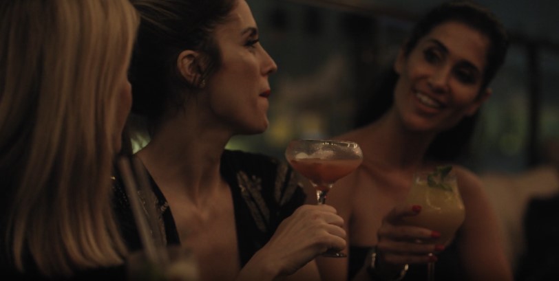 Women enjoying cocktails in a dimly lit bar