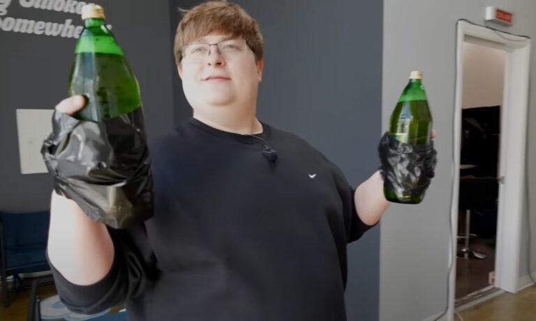A man participating in the Edward Fortyhands drinking game with two bottles in his hands